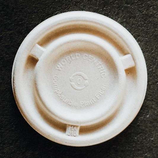 light tan cup lid made out of pulp fiber.